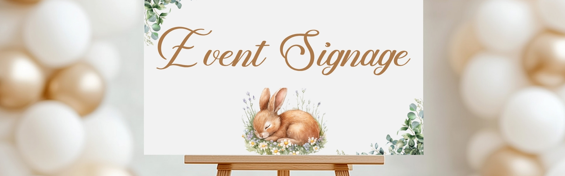 Personalized baby shower welcome sign on easel, featuring floral greenery and bunny illustration with text “Welcome to Ashley’s Baby Shower,” created by Tru Visionz Event Signage.