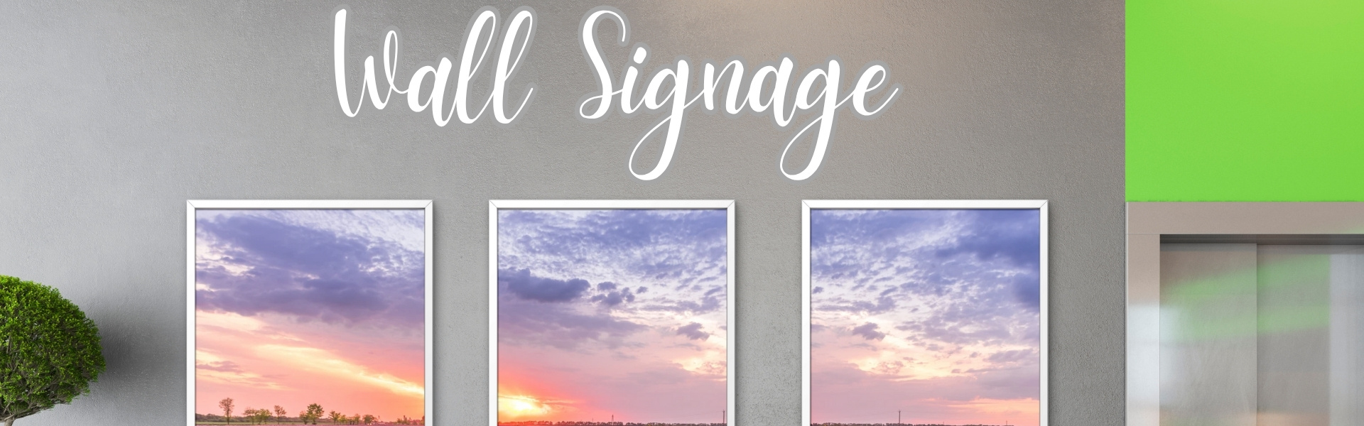 Interior wall signage with three framed floral sunset prints and vinyl text reading “Here You Bloom,” designed and installed by Tru Visionz.