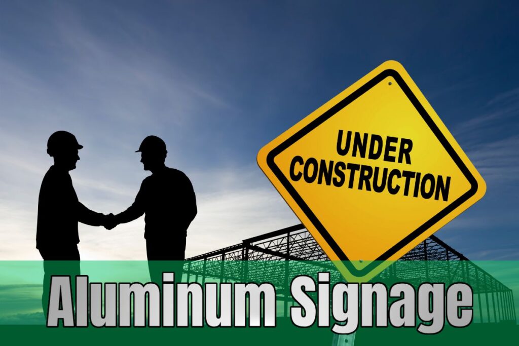 Custom aluminum “Under Construction” sign displayed outdoors with two workers in silhouette, designed by Tru Visionz Aluminum Signage.